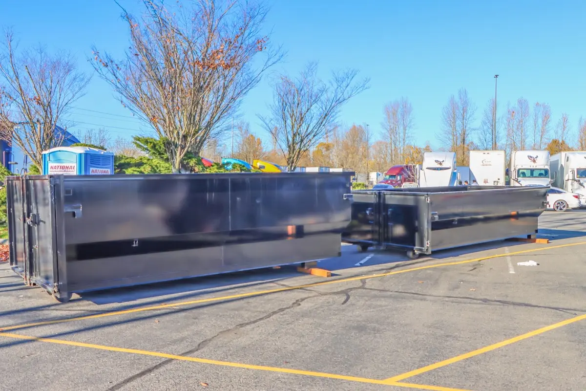 Professional dumpster rental service with roll-off container on residential driveway in Sedro-Woolley